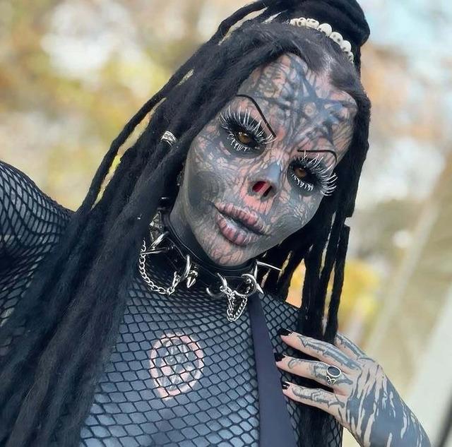 Toxii Daniëlle showcasing her heavily tattooed and modified look, with intricate designs covering her face and neck.